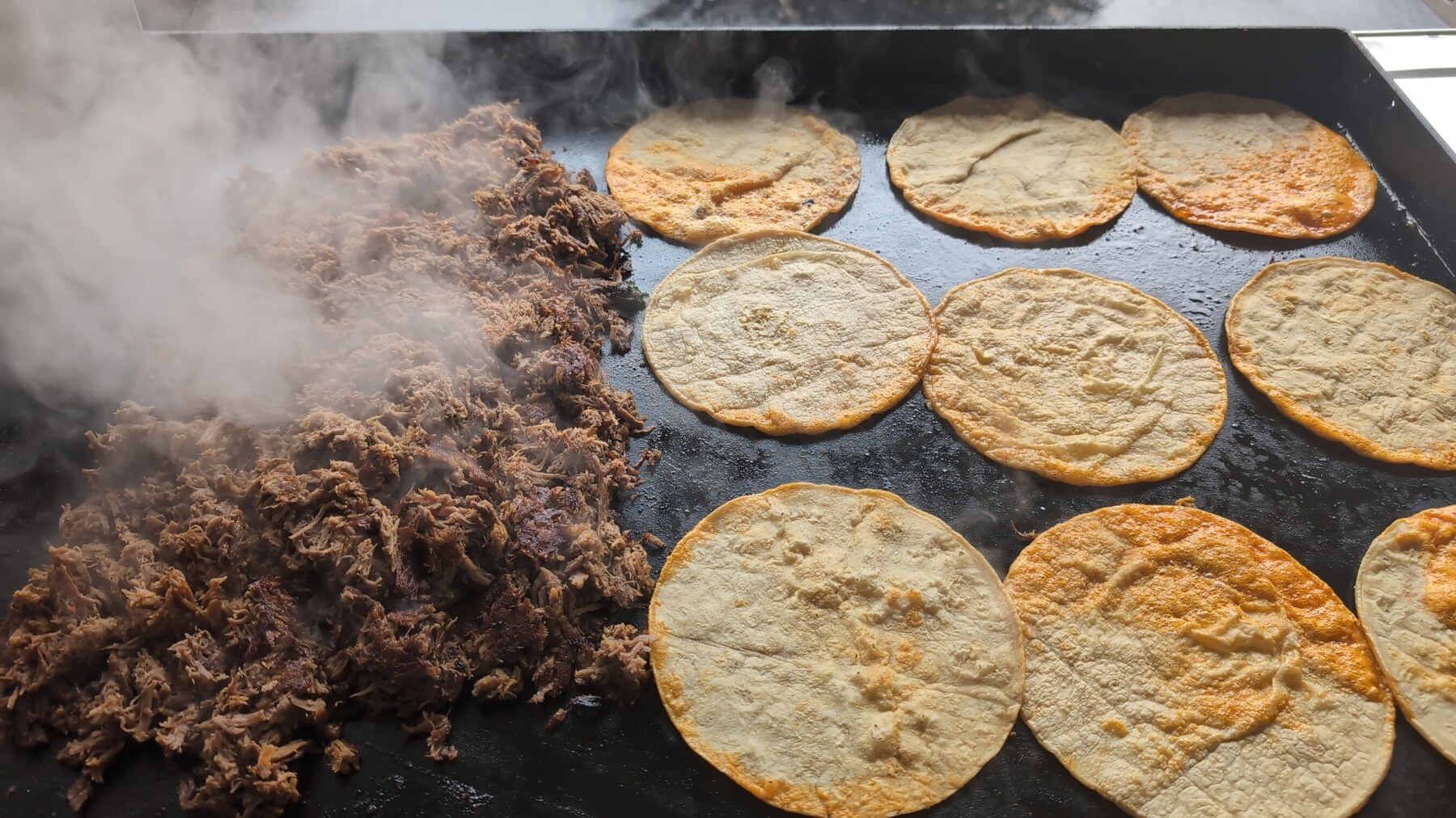 Just Dip It taquero plating birria tacos to order at an outdoor event